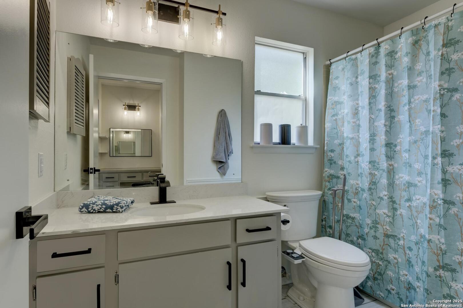 5018 Risada Street San Antonio, TX 78233 - Photo 27 of 39 a bathroom with a sink a toilet and shower
