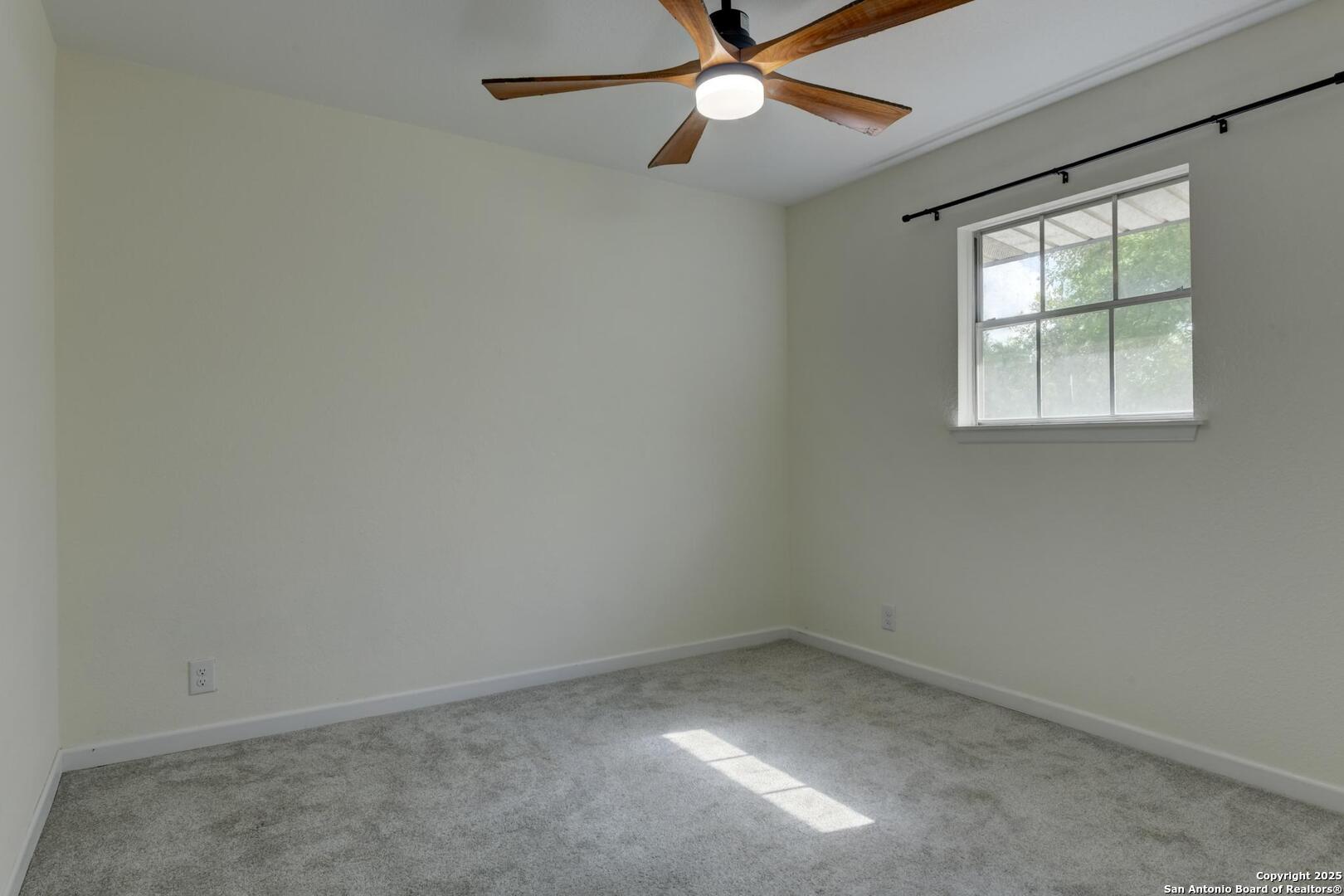 5018 Risada Street San Antonio, TX 78233 - Photo 29 of 39 an empty room with a window and a fan
