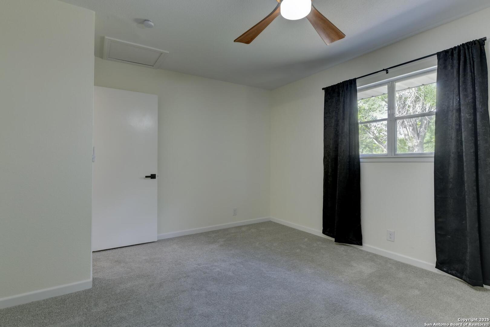 5018 Risada Street San Antonio, TX 78233 - Photo 32 of 39 an empty room with a window and a fan