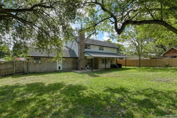 a view of a backyard with large trees