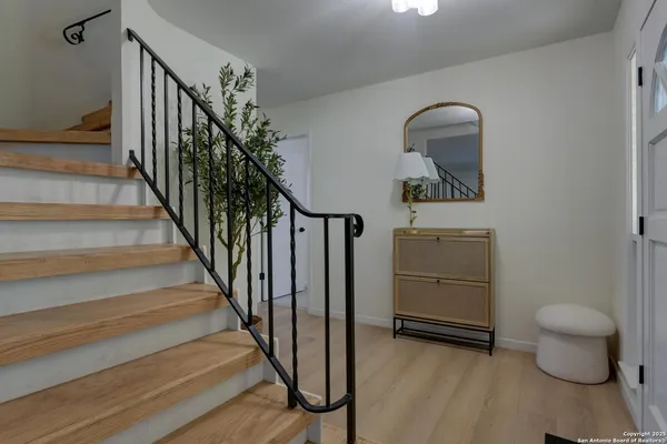 a view of entryway and hall with wooden floor