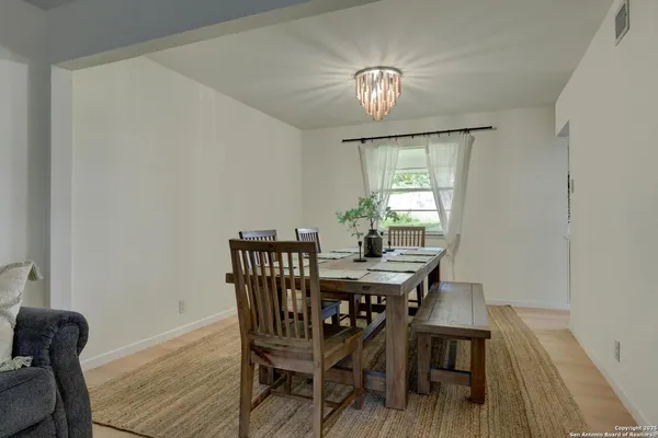 a view of a dining room with furniture wooden floor and chandelier