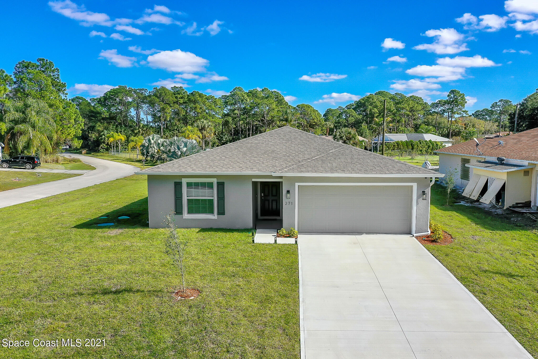 271 Wendover Road Southwest Palm Bay, FL 32908 - Photo 1 of 35 a front view of a house with yard