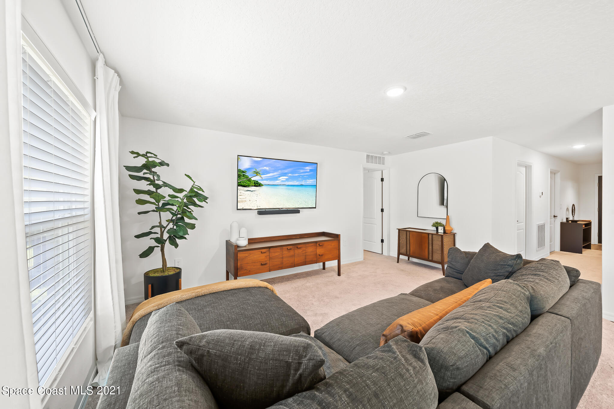 271 Wendover Road Southwest Palm Bay, FL 32908 - Photo 13 of 35 a bedroom with furniture and a potted plant