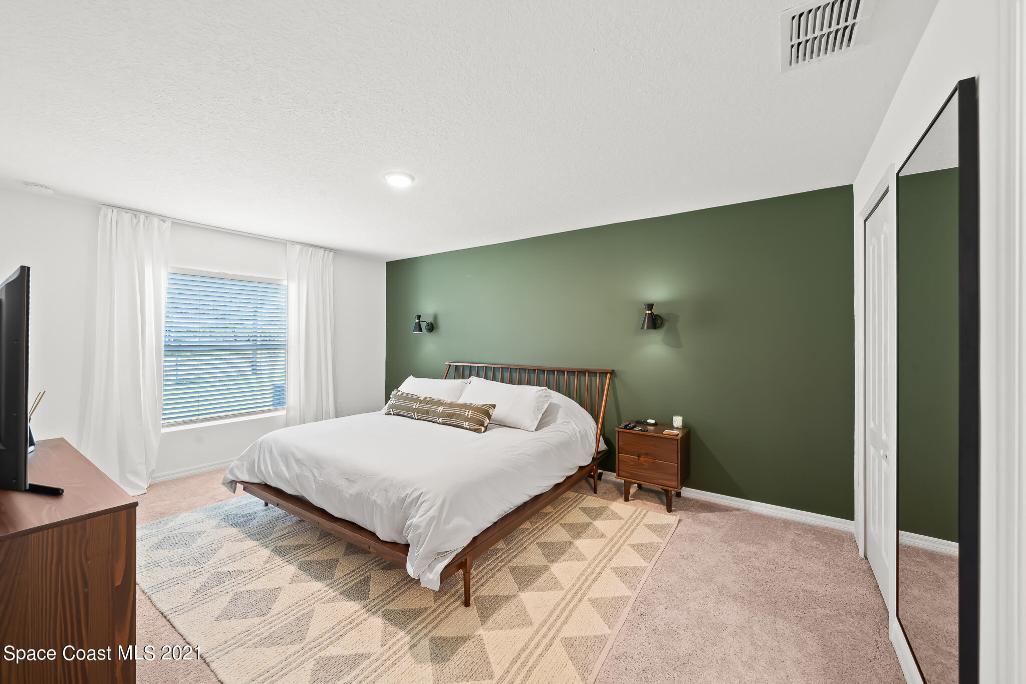 271 Wendover Road Southwest Palm Bay, FL 32908 - Photo 16 of 35 a bedroom with a bed and a flat screen tv