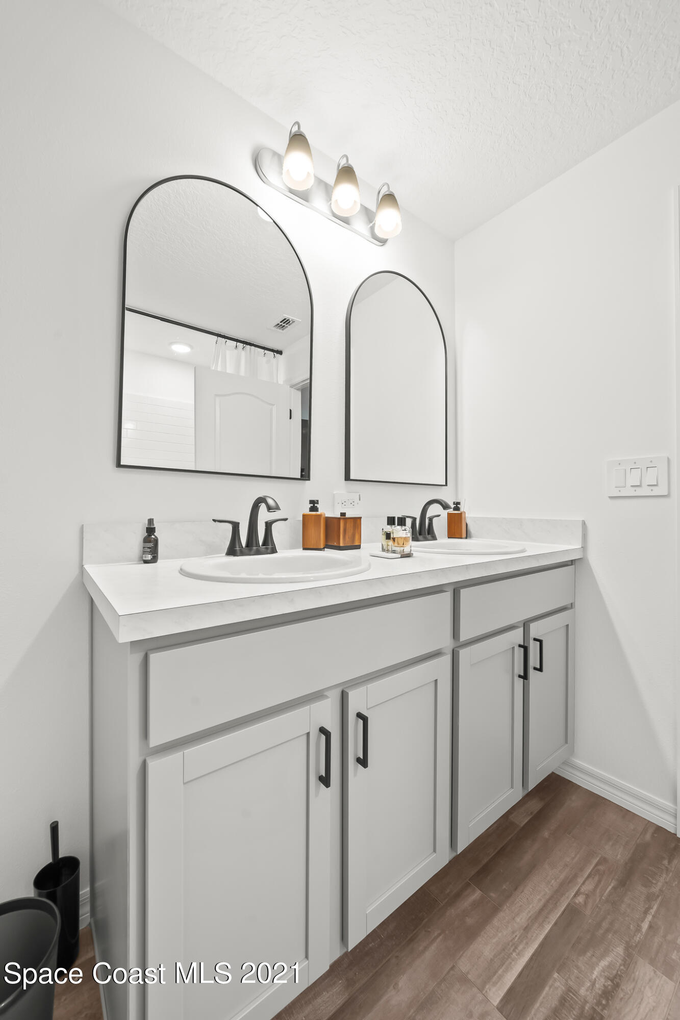 271 Wendover Road Southwest Palm Bay, FL 32908 - Photo 19 of 35 a bathroom with a double vanity sink and a mirror