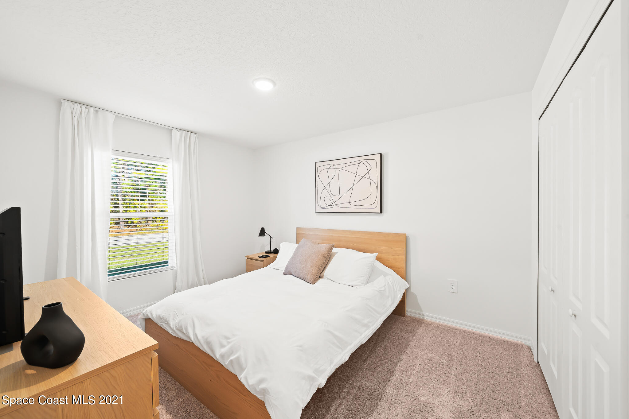 271 Wendover Road Southwest Palm Bay, FL 32908 - Photo 22 of 35 a bedroom with a bed and a window