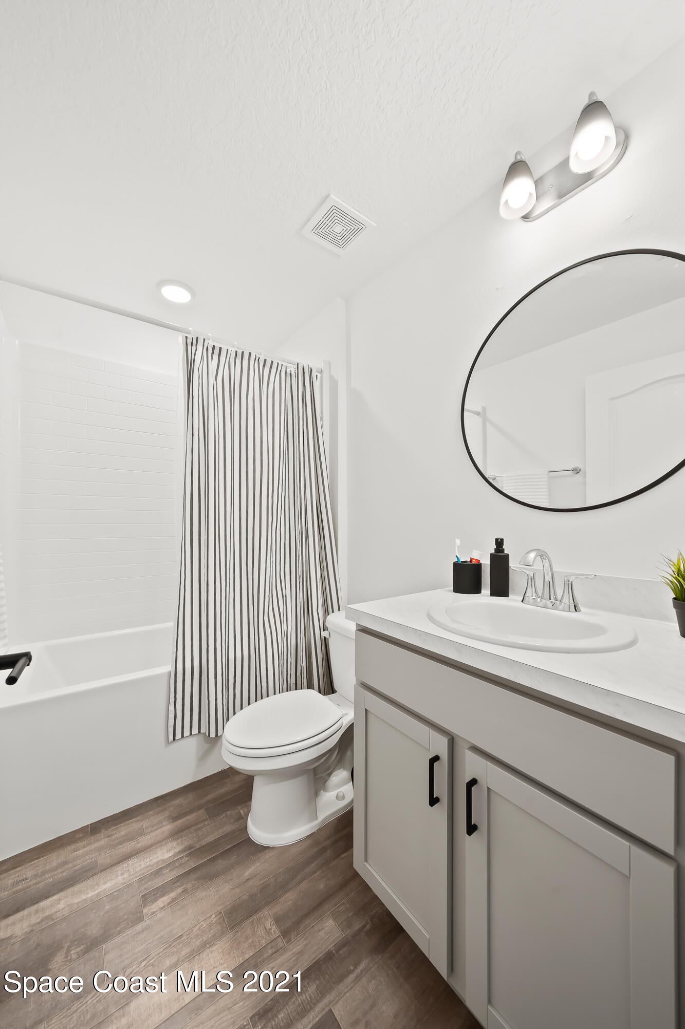 271 Wendover Road Southwest Palm Bay, FL 32908 - Photo 23 of 35 a bathroom with a sink a toilet and a mirror
