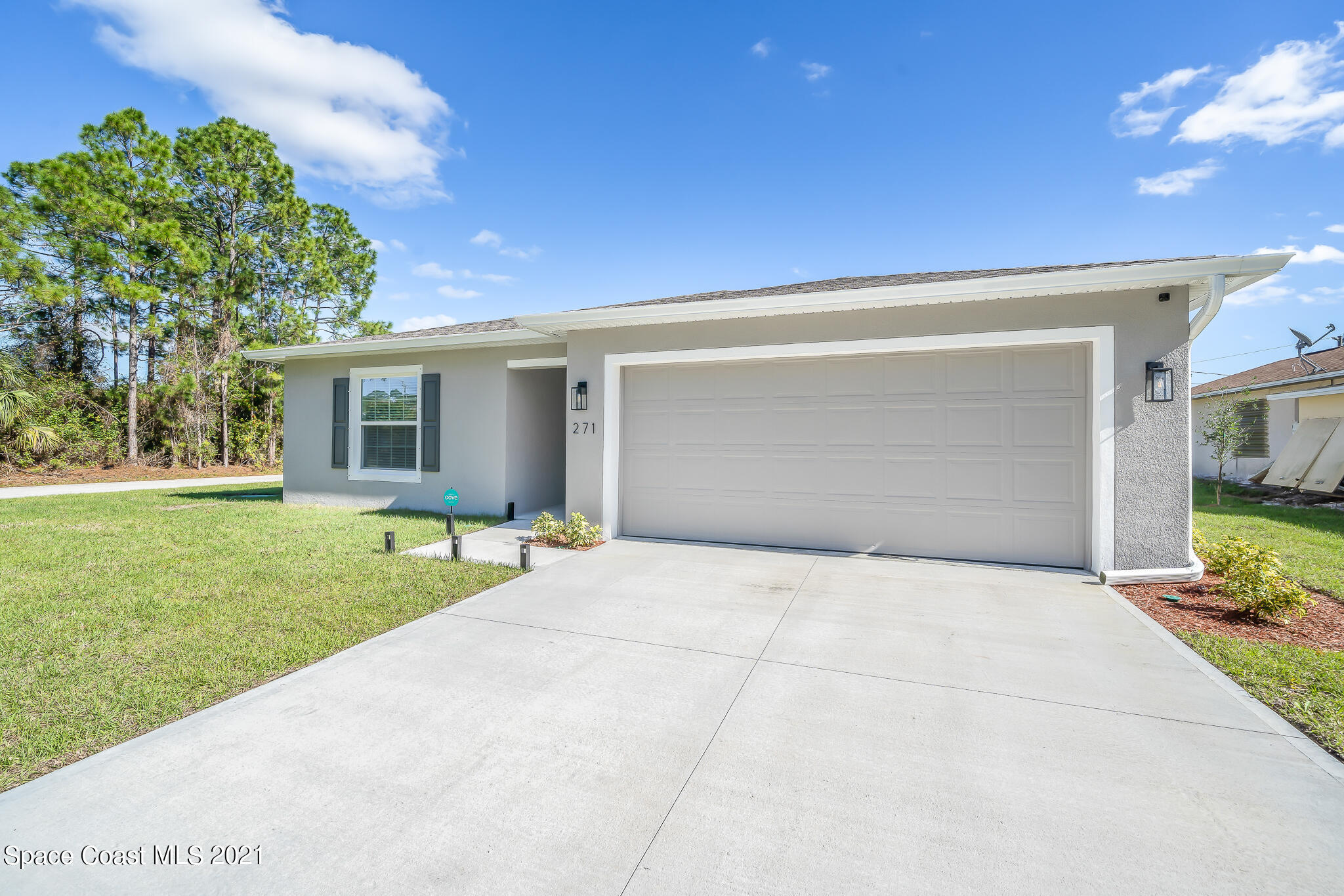 271 Wendover Road Southwest Palm Bay, FL 32908 - Photo 4 of 35 a front view of a house with a yard and garage