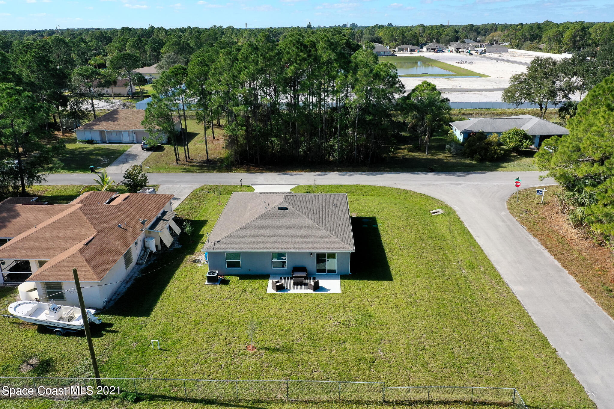 271 Wendover Road Southwest Palm Bay, FL 32908 - Photo 35 of 35 an aerial view of a house with swimming pool and large trees