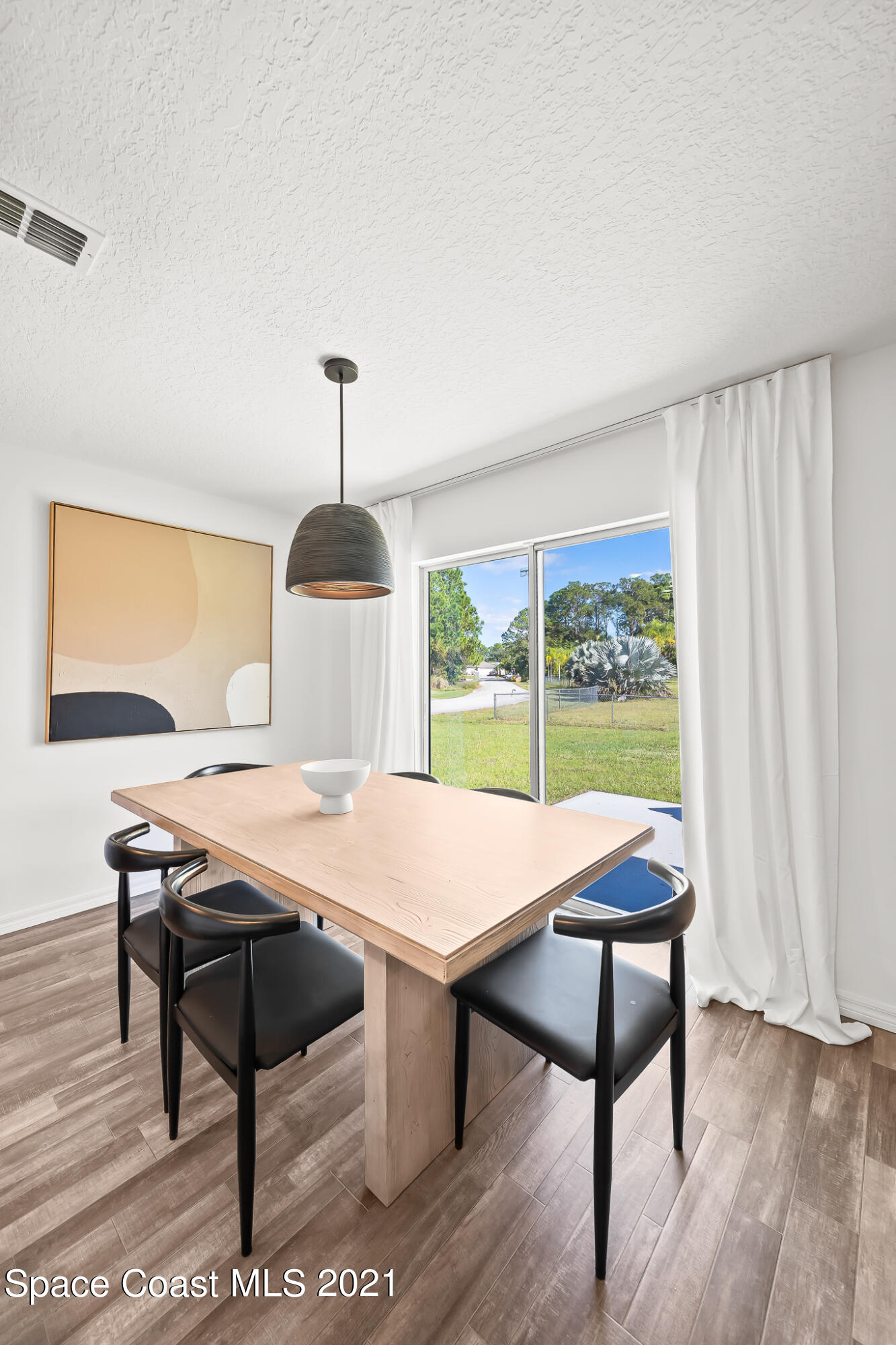 271 Wendover Road Southwest Palm Bay, FL 32908 - Photo 9 of 35 a table and chairs in a room
