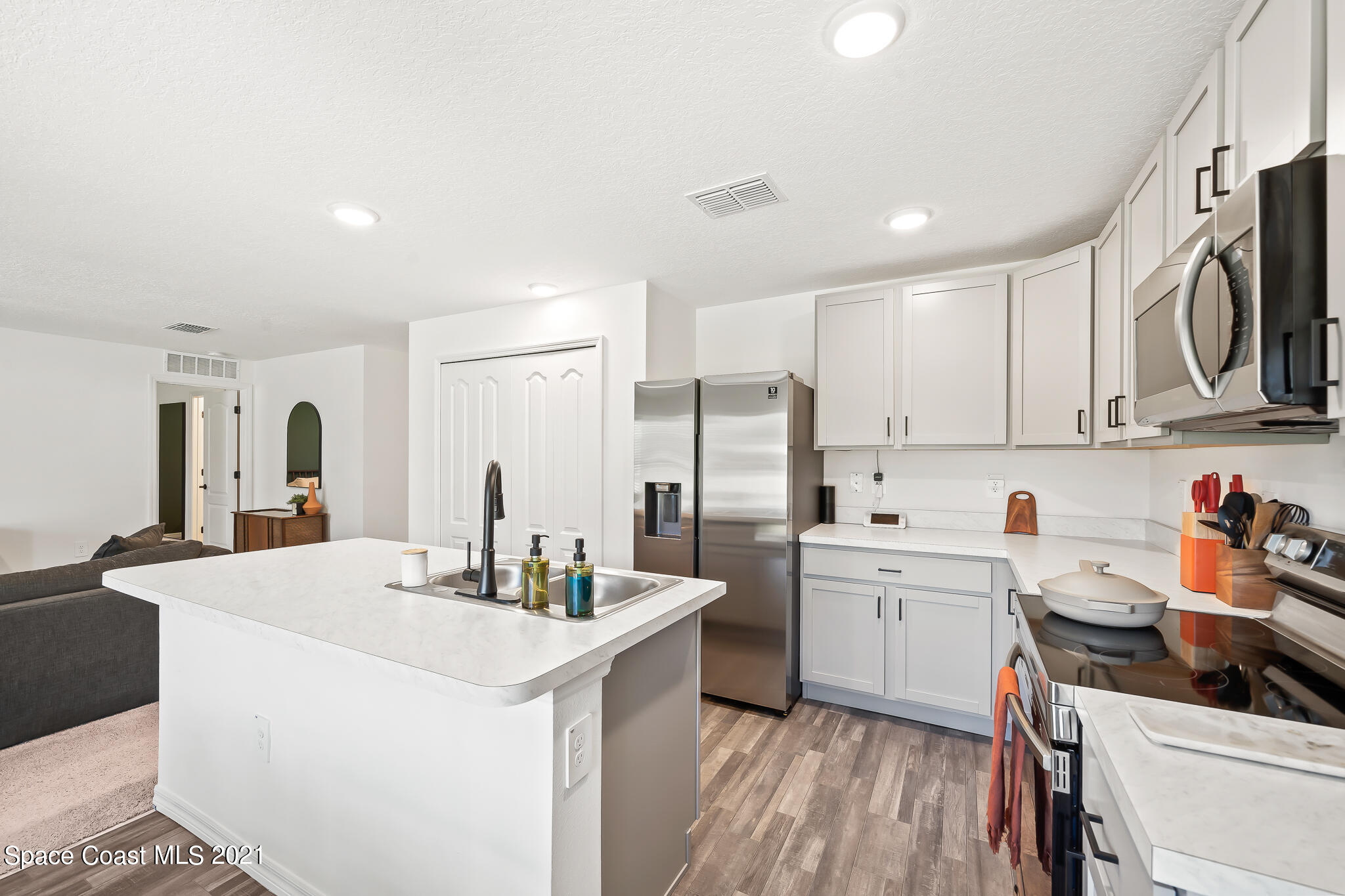 271 Wendover Road Southwest Palm Bay, FL 32908 - Photo 10 of 35 a kitchen with stainless steel appliances a sink stove and refrigerator