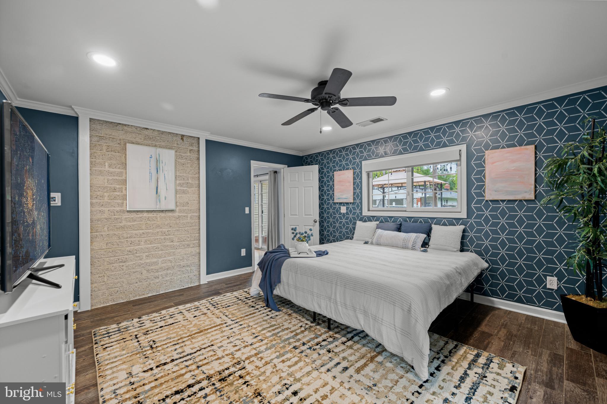 1410 Valley Creek Road Severn, MD 21144 - Photo 18 of 47 a bedroom with a bed and a chandelier