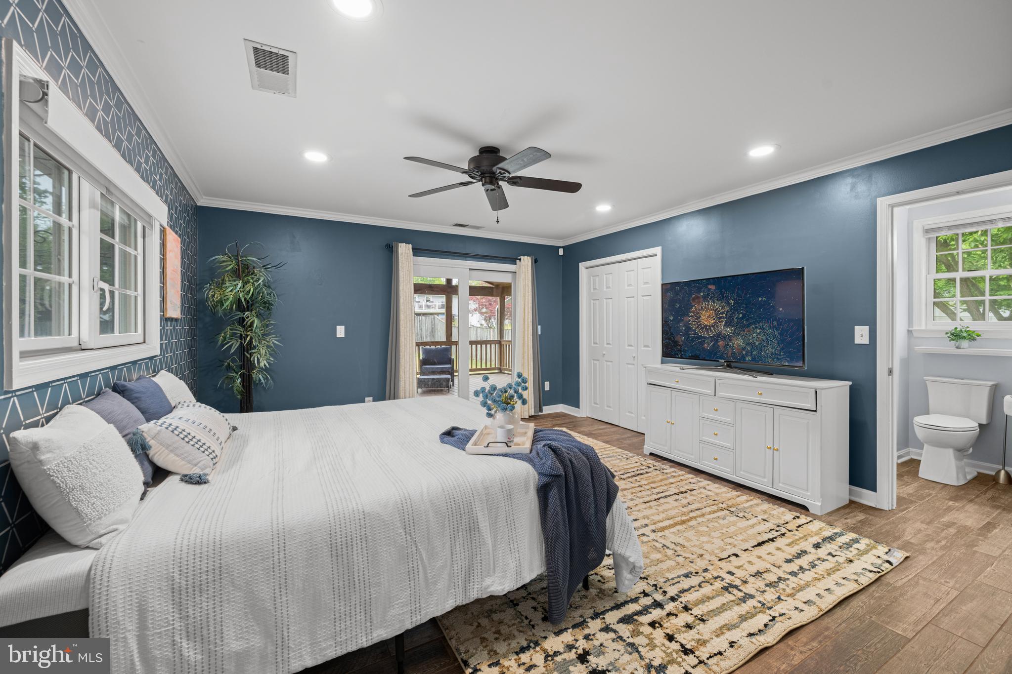 1410 Valley Creek Road Severn, MD 21144 - Photo 19 of 47 a bedroom with a bed and a chandelier