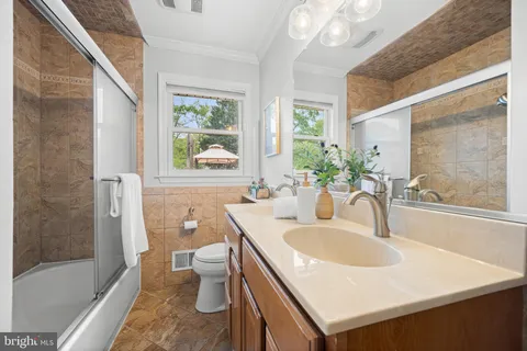 a bathroom with a sink and a large mirror