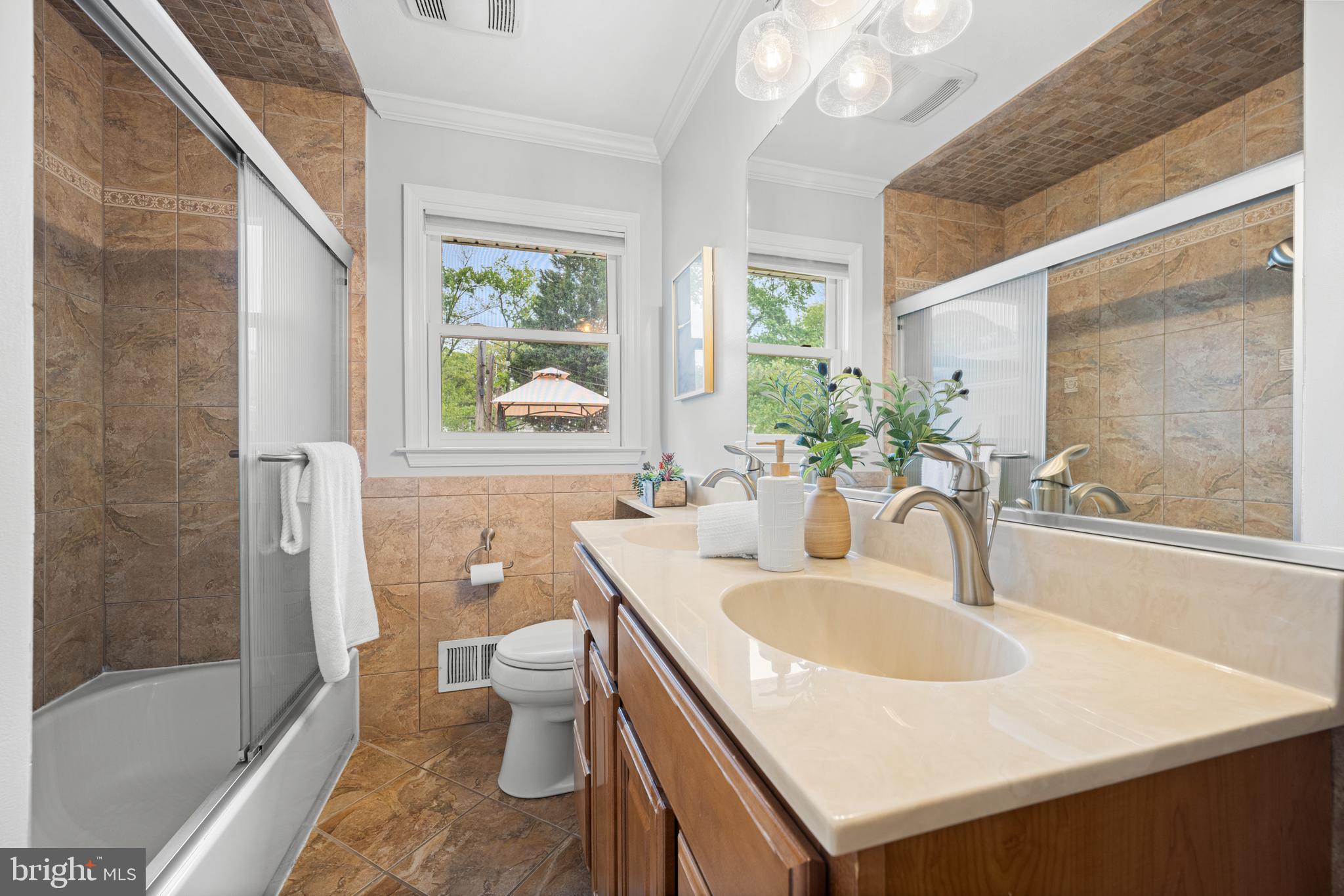1410 Valley Creek Road Severn, MD 21144 - Photo 21 of 47 a bathroom with a sink and a large mirror