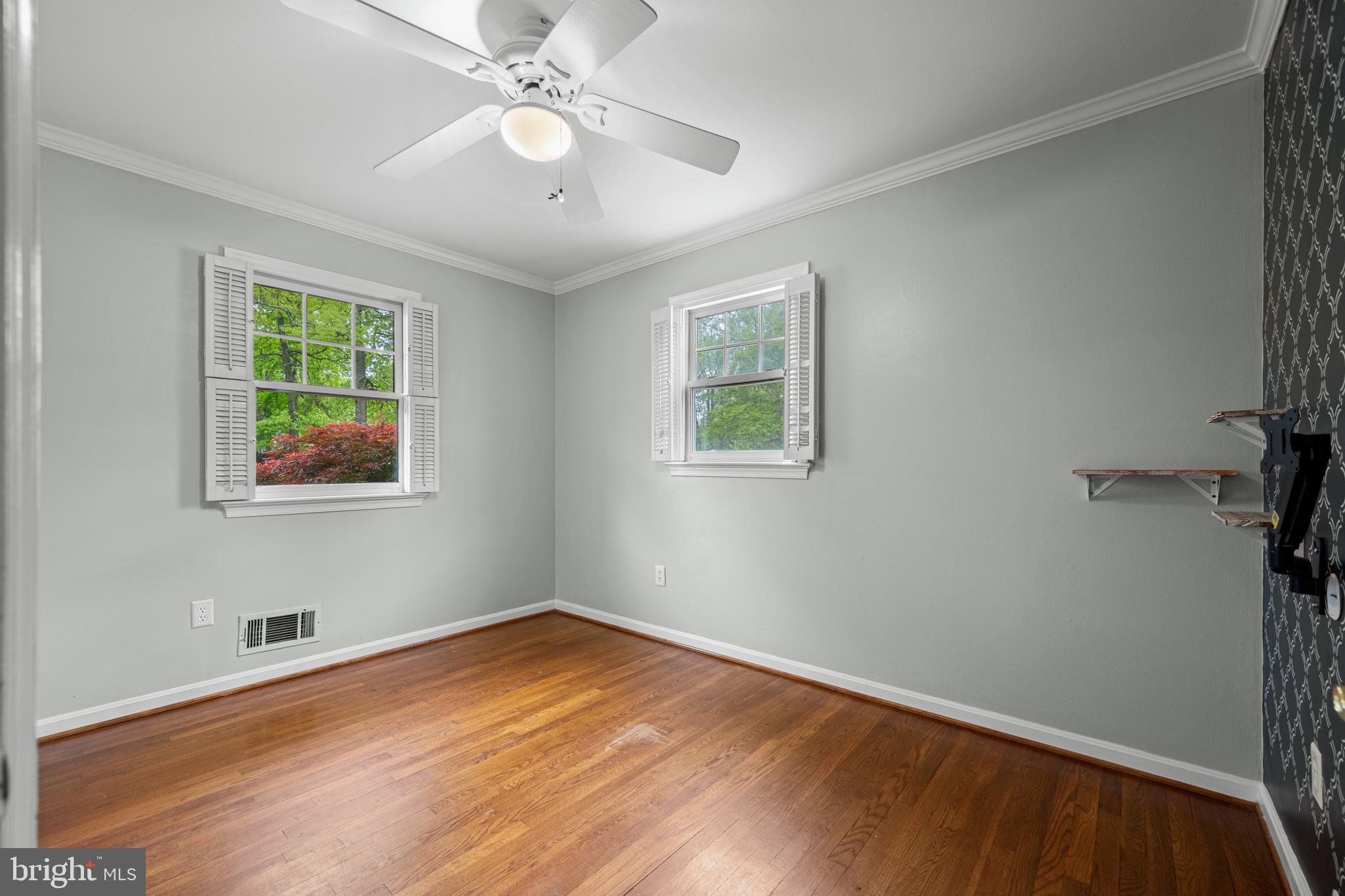 1410 Valley Creek Road Severn, MD 21144 - Photo 28 of 47 a view of an empty room with wooden floor and a window