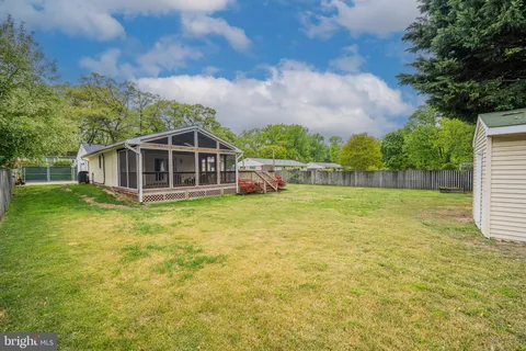 a view of a house with a yard and sitting area