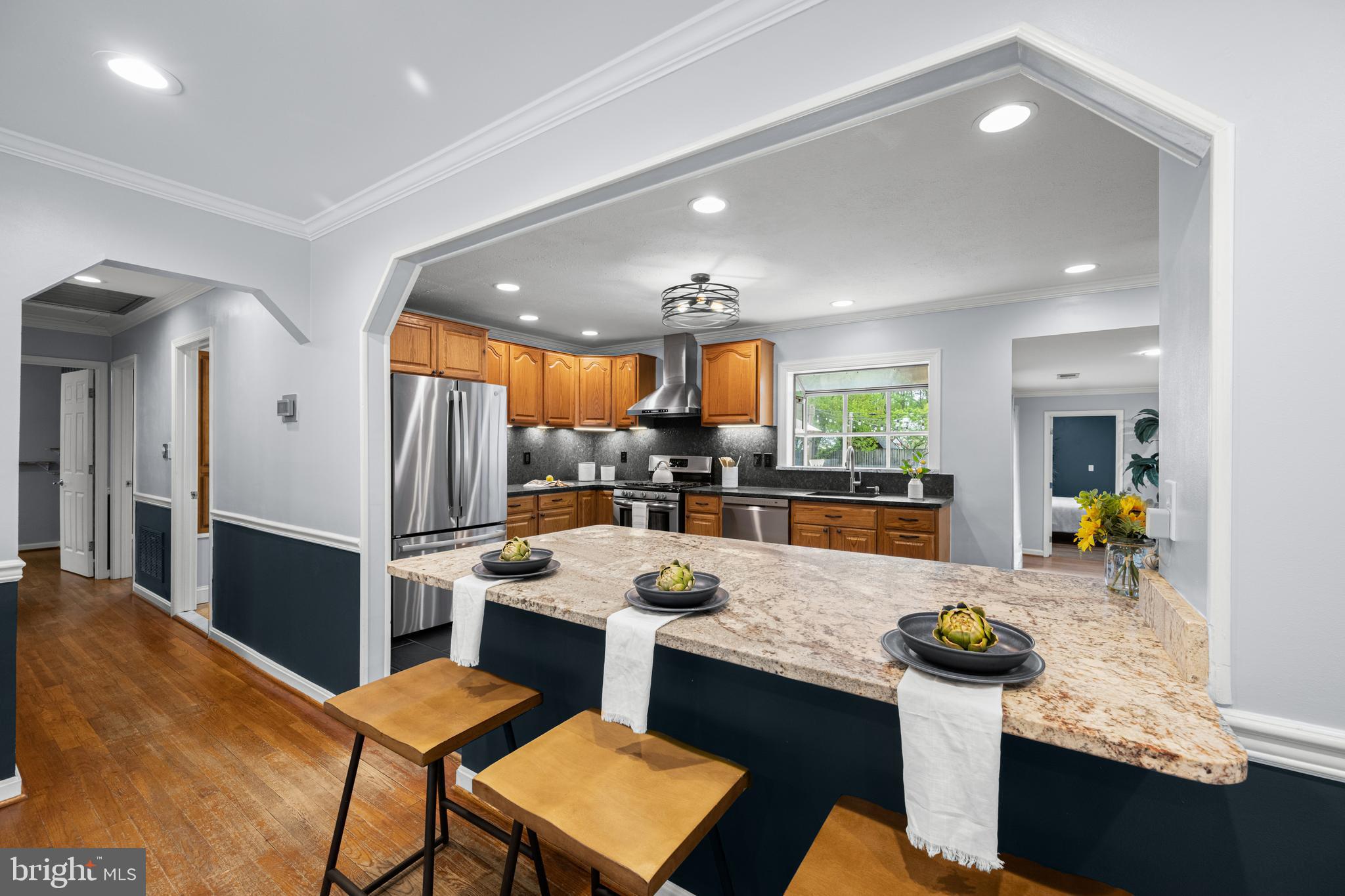 1410 Valley Creek Road Severn, MD 21144 - Photo 10 of 47 a kitchen with a sink a counter and chairs