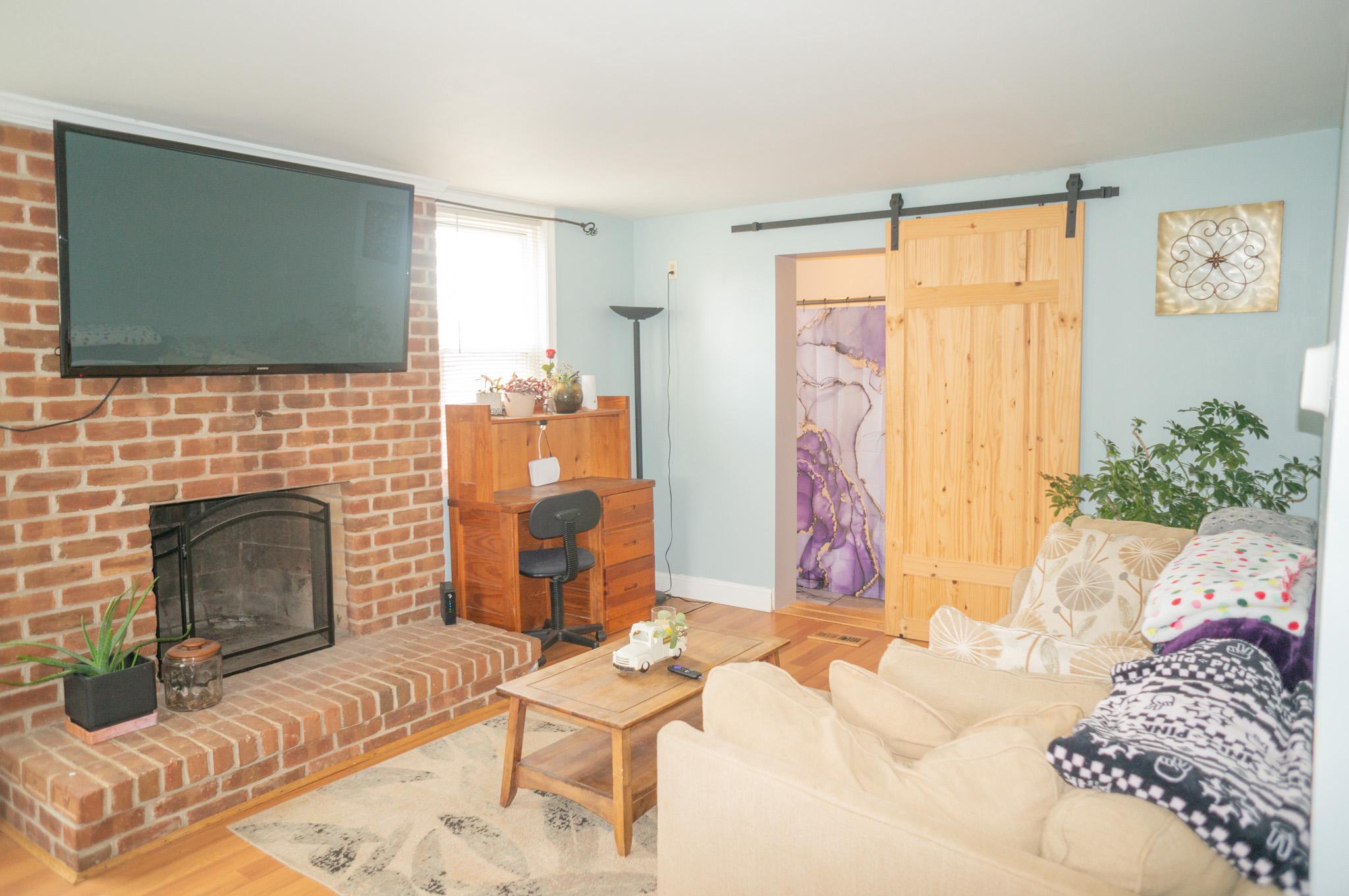 14803 Mt Olivet Road Stewartstown, PA 17363 - Photo 36 of 81 a living room with furniture and a fireplace