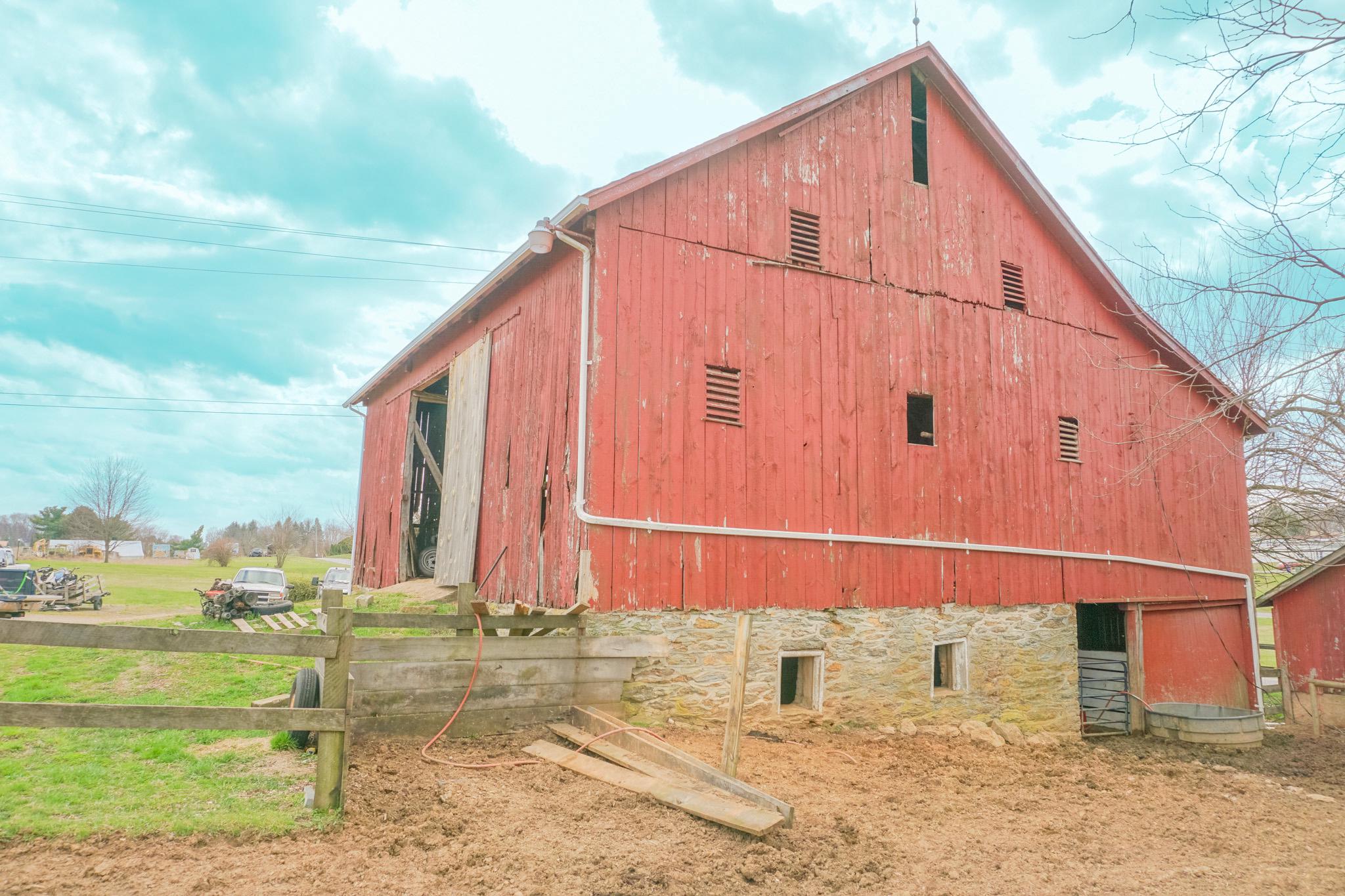 14803 Mt Olivet Road Stewartstown, PA 17363 - Photo 70 of 81 Rustic red barn amidst open fields.