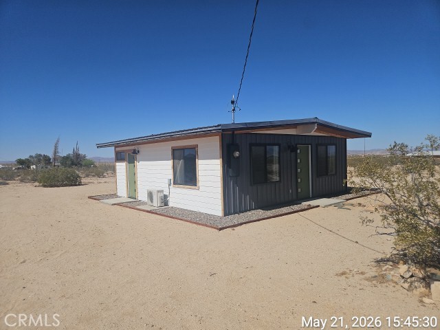 65154 Hoover Aka Mars St Road Joshua Tree, CA 92252 - Photo 2 of 11 a front view of a house with a yard