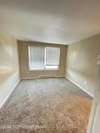 an empty room with a empty space and windows