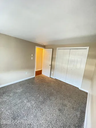 an empty room with an empty space and mirror