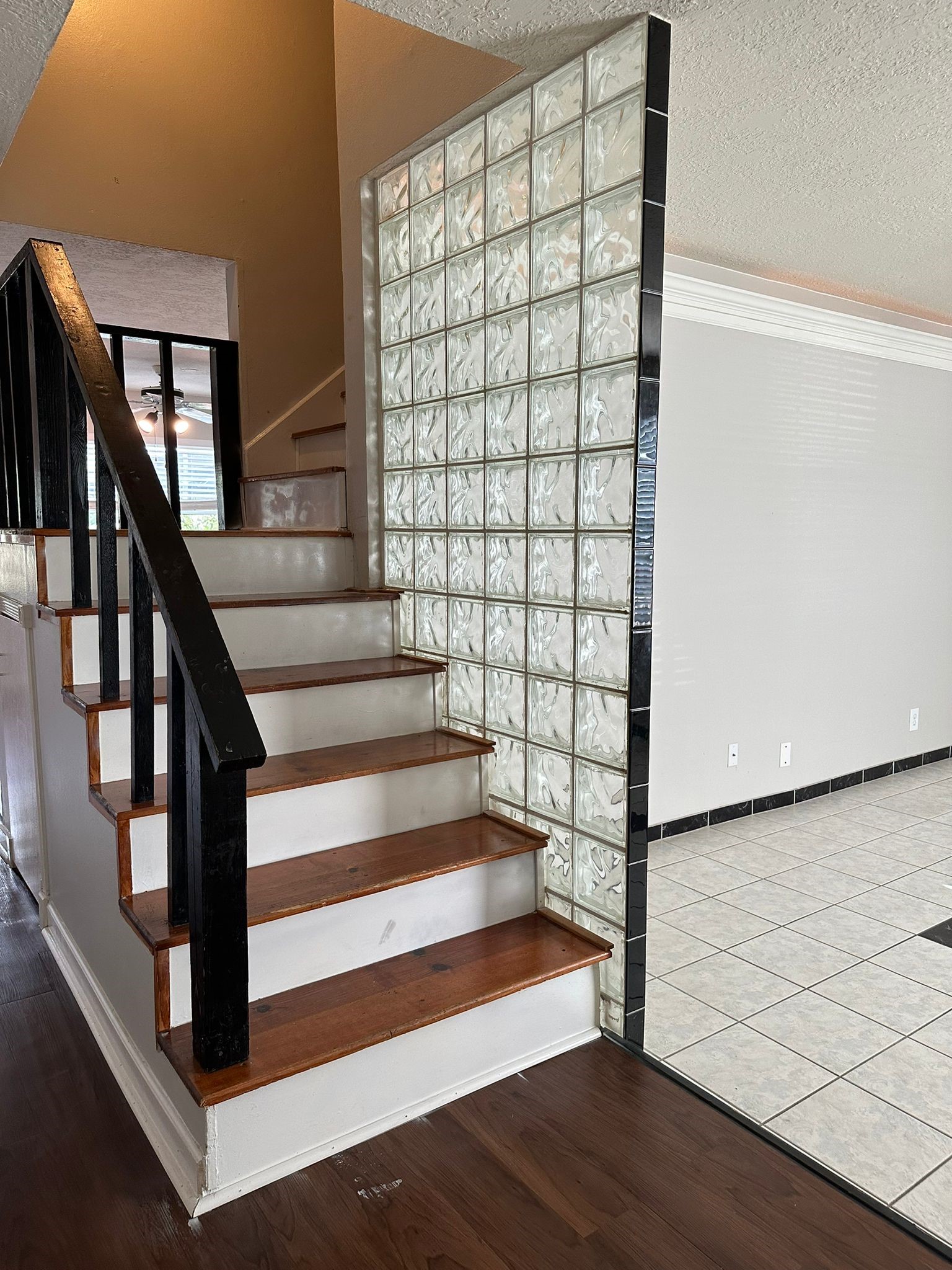 7305 South Gessner Road Houston, TX 77036 - Photo 5 of 24 a view of entryway with wooden floor and stairs