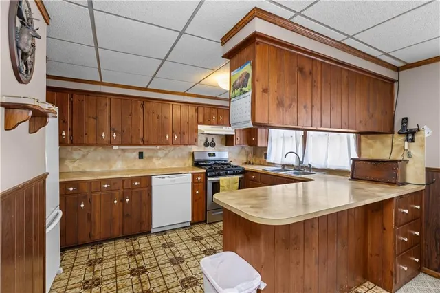a kitchen with stainless steel appliances granite countertop a sink stove and cabinets