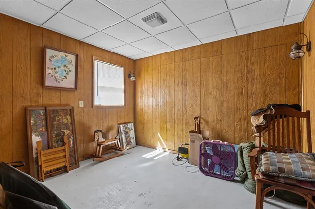 a bathroom with a tub a sink and a large mirror