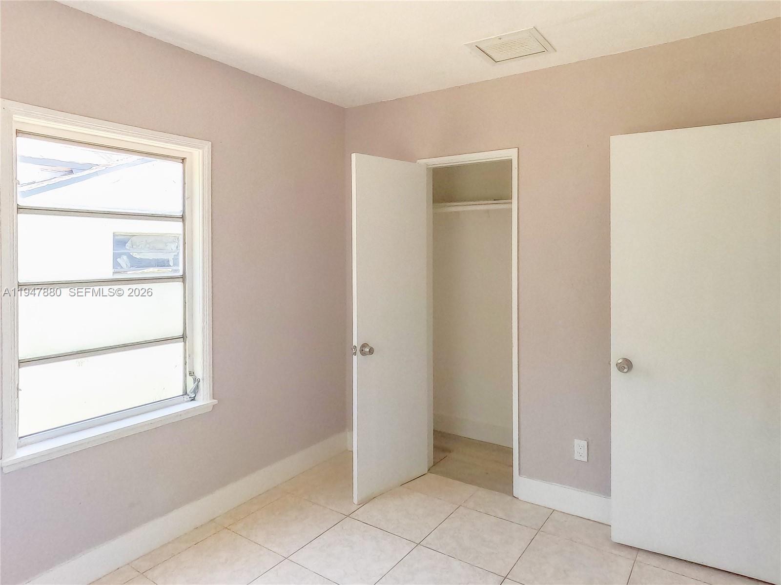 1051 Northwest 63rd Street Miami, FL 33150 - Photo 11 of 30 a view of an empty room with window