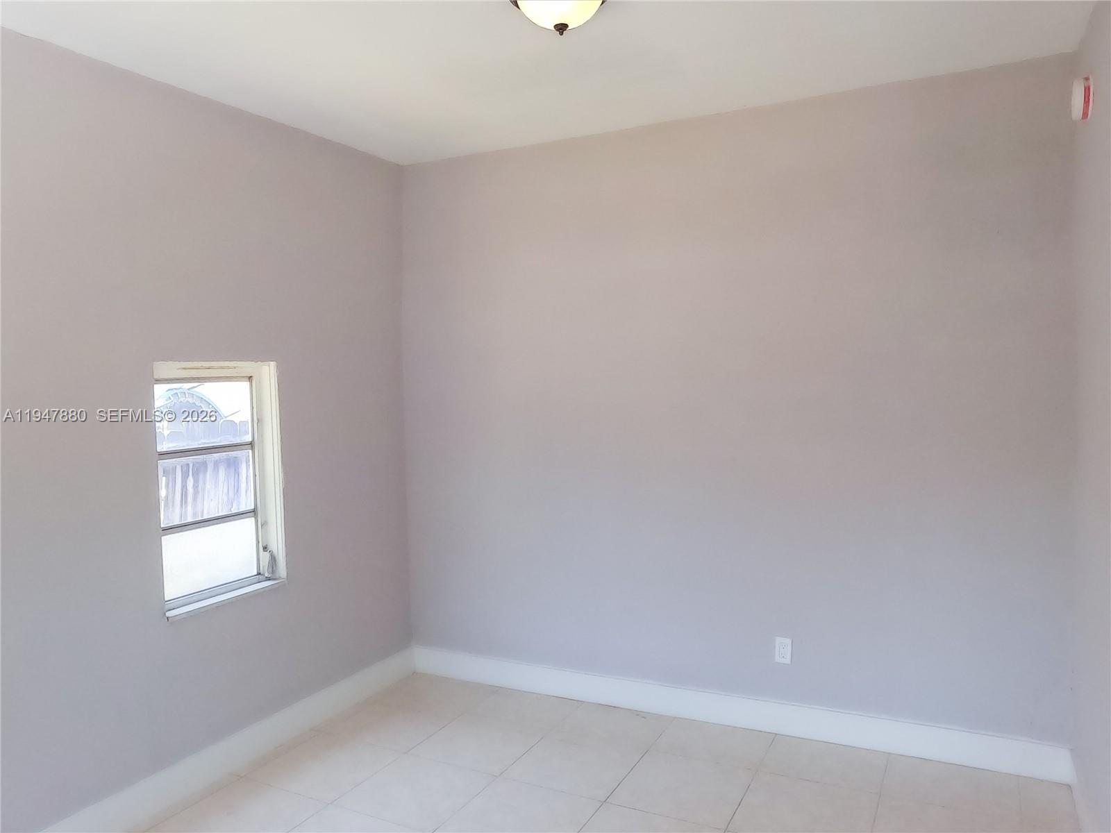 1051 Northwest 63rd Street Miami, FL 33150 - Photo 12 of 30 a view of an empty room with a window