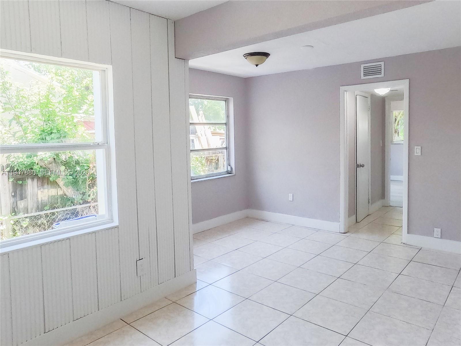 1051 Northwest 63rd Street Miami, FL 33150 - Photo 13 of 30 an empty room with windows
