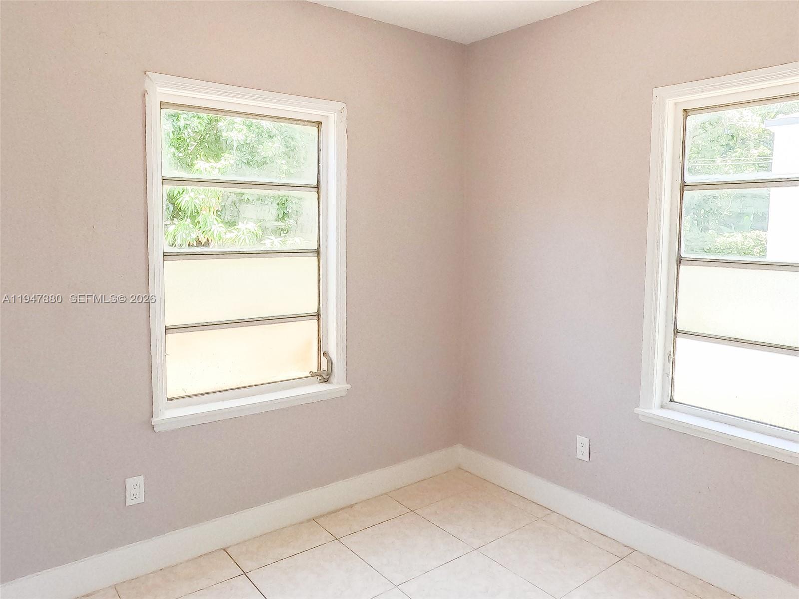 1051 Northwest 63rd Street Miami, FL 33150 - Photo 16 of 30 an empty room with a window