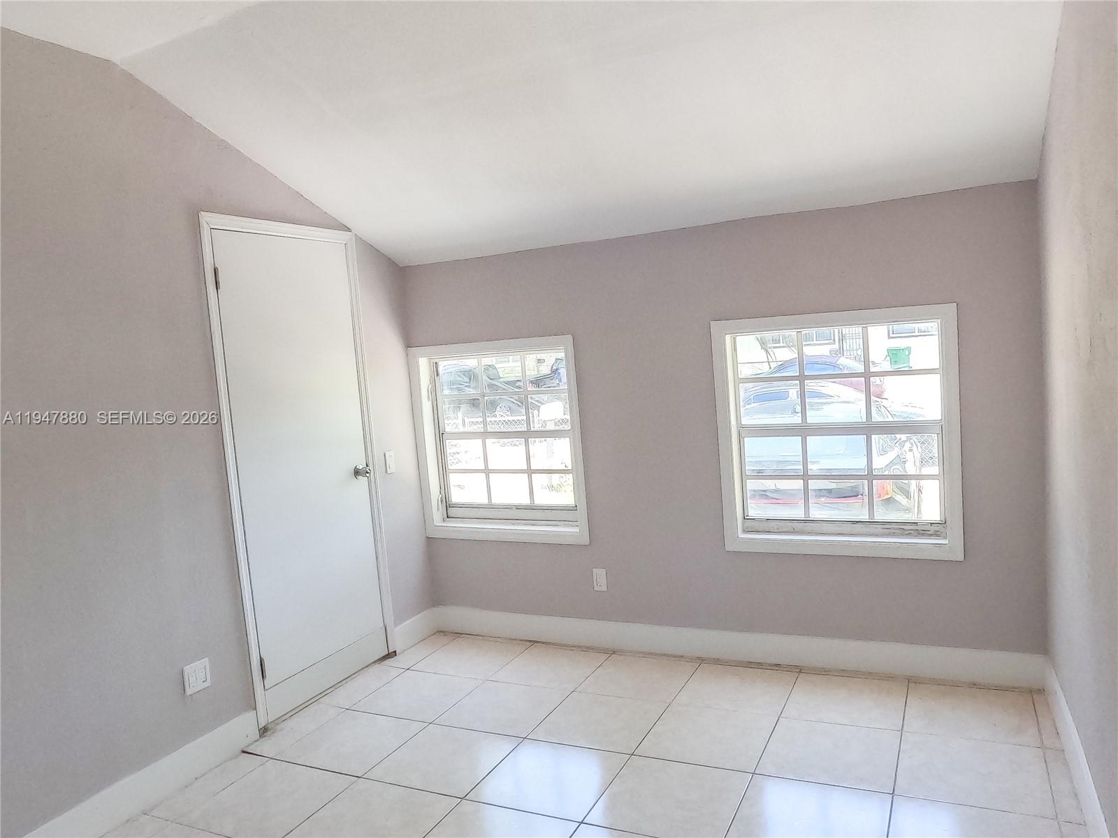 1051 Northwest 63rd Street Miami, FL 33150 - Photo 22 of 30 an empty room with windows