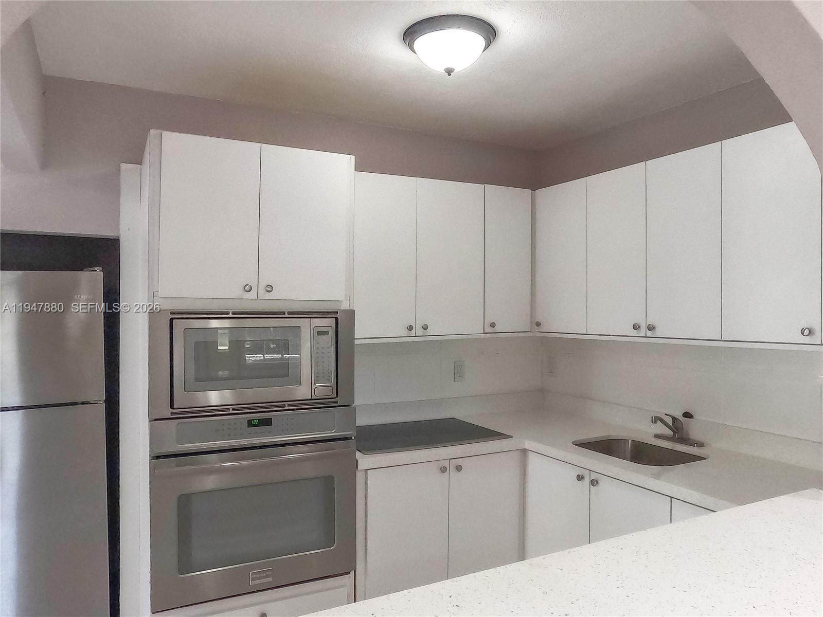 1051 Northwest 63rd Street Miami, FL 33150 - Photo 23 of 30 a kitchen with a sink cabinets and stainless steel appliances