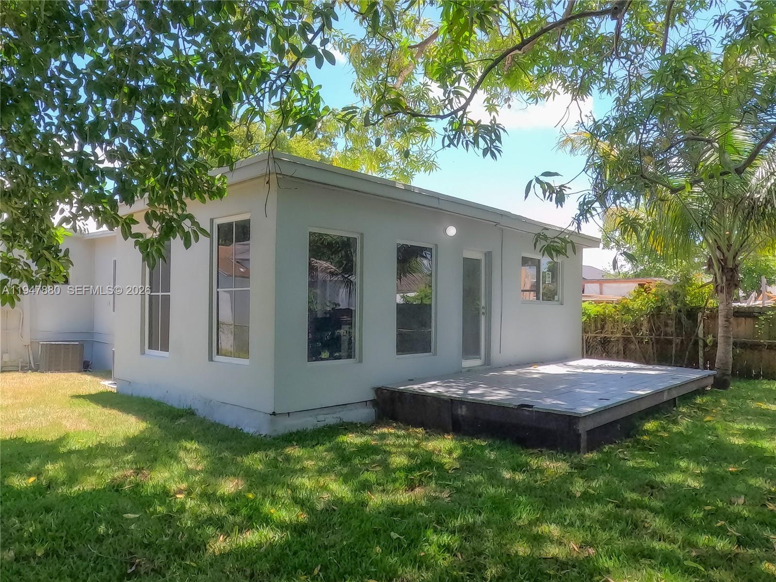 1051 Northwest 63rd Street Miami, FL 33150 - Photo 27 of 30 a view of a house with a yard