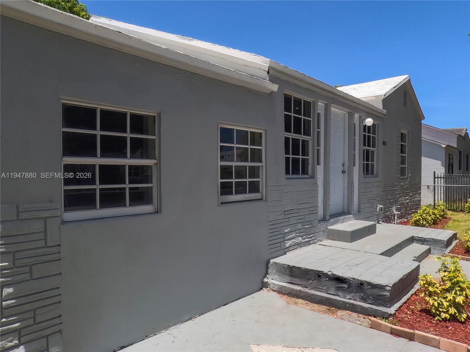 1051 Northwest 63rd Street Miami, FL 33150 - Photo 29 of 30 a front view of a house with windows