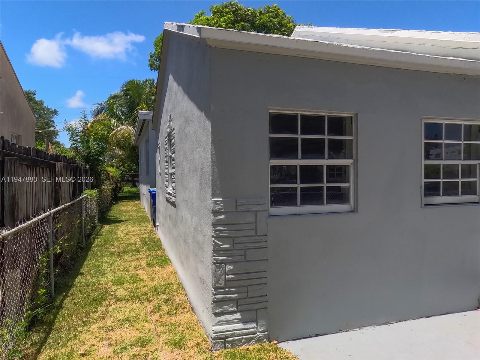 1051 Northwest 63rd Street Miami, FL 33150 - Photo 30 of 30 a view of balcony with wooden floor and a potted plant