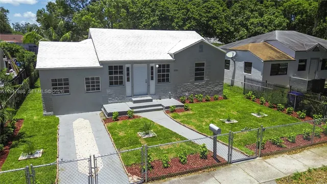 a aerial view of a house with porch and a garden