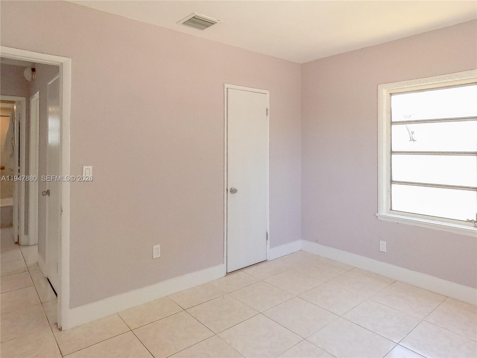 1051 Northwest 63rd Street Miami, FL 33150 - Photo 10 of 30 an empty room with windows