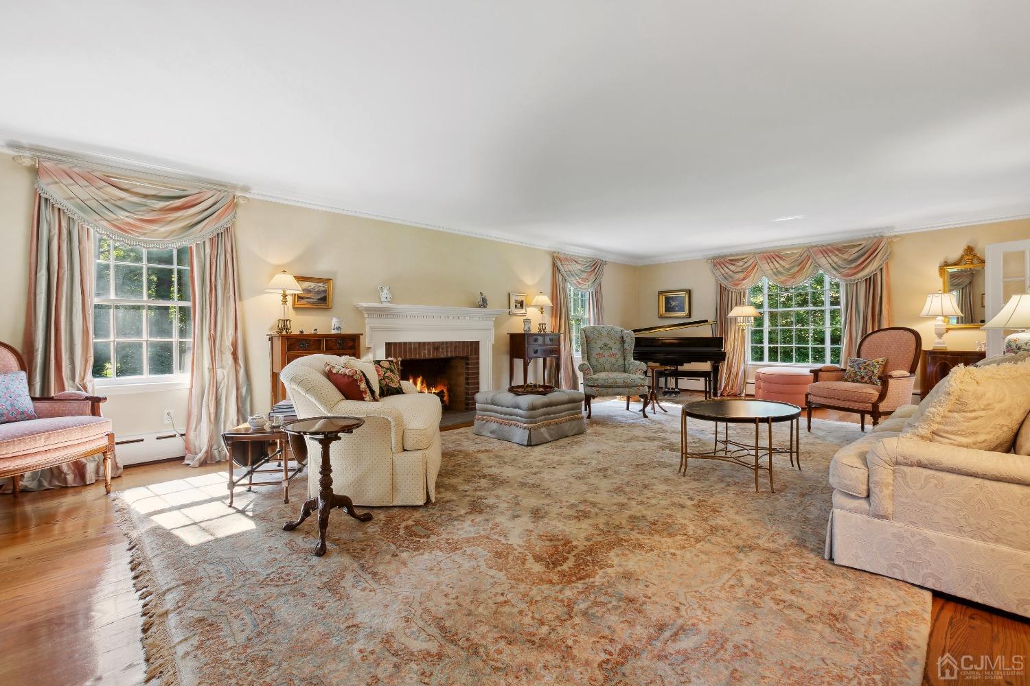32 Oak Hills Road Edison, NJ 08820 - Photo 13 of 54 a living room with furniture a fireplace and a large window