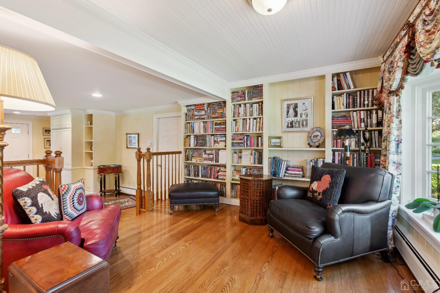 32 Oak Hills Road Edison, NJ 08820 - Photo 25 of 54 a living room with furniture a rug and a book shelf