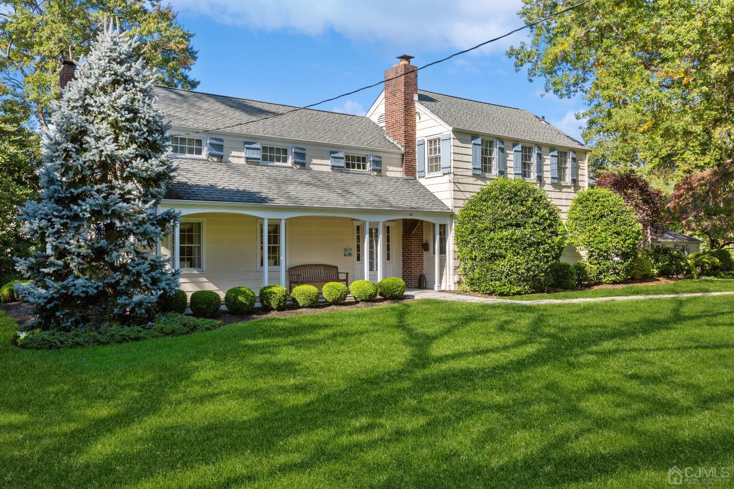 32 Oak Hills Road Edison, NJ 08820 - Photo 3 of 54 a front view of a house with a garden