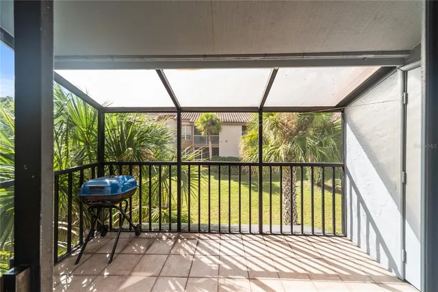 a view of a room with a large window and chairs