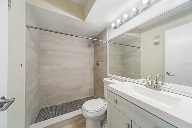 a view of a livingroom with a hardwood floor and a ceiling fan
