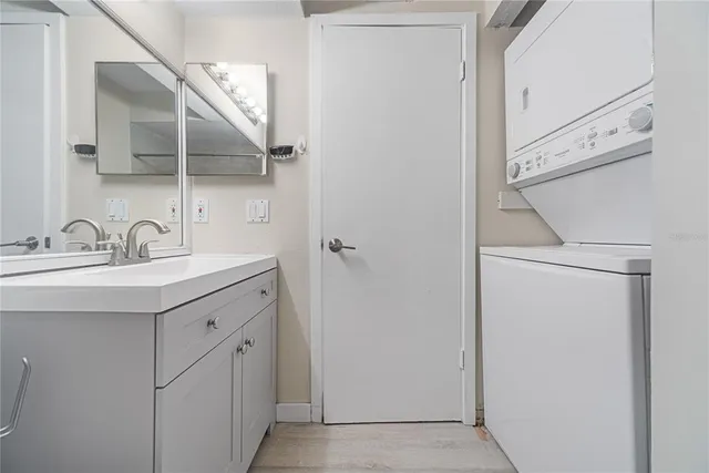 a kitchen with granite countertop a refrigerator and a stove top oven
