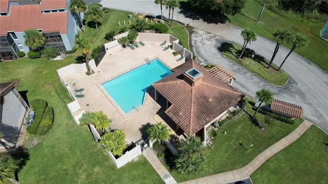 an aerial view of a house with garden space and street view