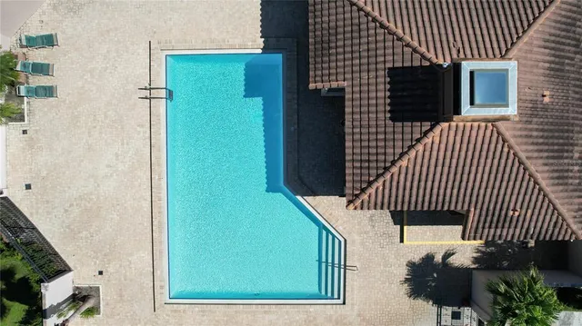 a front view of a house with a yard and potted plants